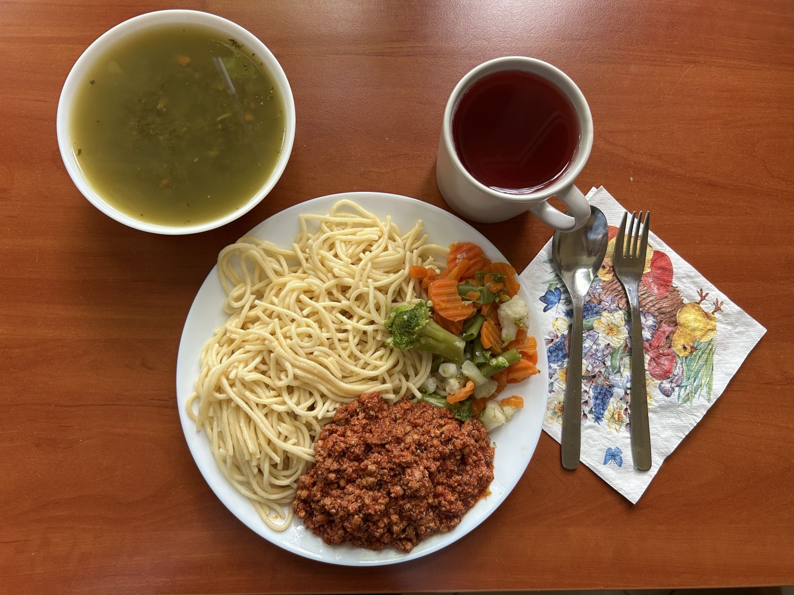 Zupa szczawiowa, sos boloński, makaron spaghetti, warzywa gotowane, kompot